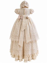 Load image into Gallery viewer, An ivory-colored lace-and-embroidered dress with a matching bonnet, featuring a large ribbon bow at the back waist, was displayed on a mannequin against a white background.