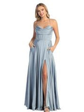 Load image into Gallery viewer, A young lady wearing a long gown with a halter neckline, corset boning, and side slit in the color dusty blue.
