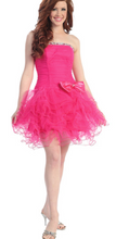 Load image into Gallery viewer, A young woman wearing a hot pink prom dress
