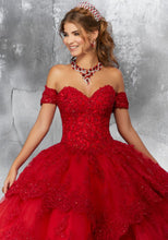 Load image into Gallery viewer, A young lady wearing a tiered ballgown with off-shoulder sleeves in the color red.
