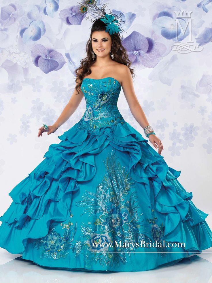 A young lady wearing a teal ruffled ballgown.