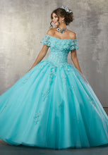 Load image into Gallery viewer, A young lady wearing an aqua ballgown with flounced neckline.
